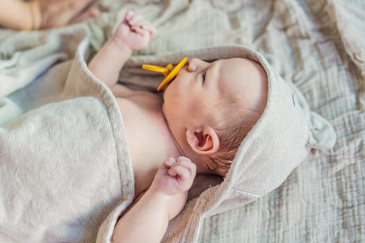 Baby after shower wrapped in a towel. This adorable moment captures the freshness and comfort of a clean baby, highlighting the tender care and love in the daily routine.