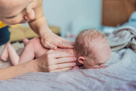 The newborn's skin is peeling. Mom uses skin products and massages to care for and soothe the baby's delicate skin, ensuring comfort and promoting healthy skin.