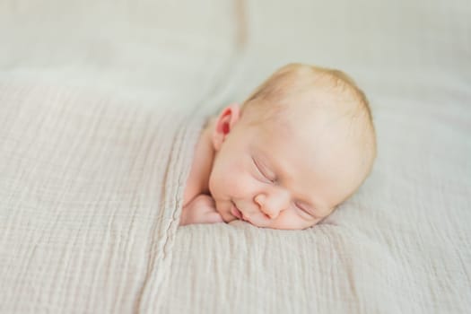 The baby is sleeping peacefully in his cozy nest. Newborn photo session captures the serene innocence and warmth of early moments.