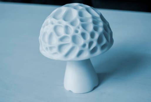 Object in the form of mushroom of white color printed on a 3D printer. Three-dimensional model printed on a 3D printer from molten plastic of red color. Concept 3D Printing. FDM 3D Printing technology