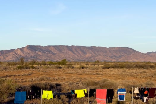 Colorful laundry hanging with Ikara Flinders Ranges backdrop, capturing everyday life in Parachilna.