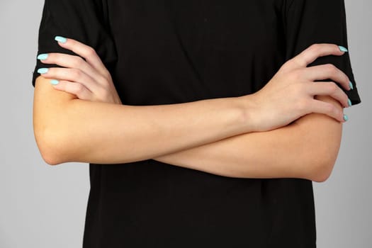 Woman Holding Hands Together With Blue Fingernails close up