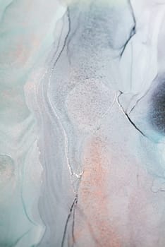 A close-up photograph of an abstract painting featuring silver and grey ink swirls on a white background.