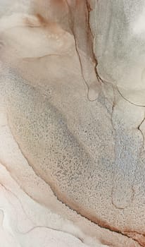 A close-up photograph of a beautiful abstract sand dune, showcasing a natural texture and patterns in hues of beige and brown.