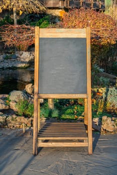 Empty wooden framed chalkboard display for restaurant menus . photo
