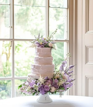 Wedding cake with lavender flowers. Festive table decoration.