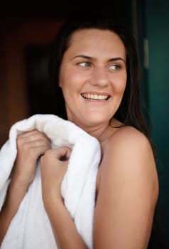 Morning at the campsite. Young naked woman wipes herself with a towel after a shower at a campsite.