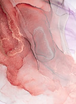 A close-up abstract image of swirling ink in shades of rose gold and grey. The intricate patterns create a unique and mesmerizing visual experience.