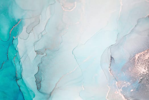 A close-up abstract image featuring a swirl of teal, blue, and silver ink. The colors blend seamlessly, creating a beautiful and mesmerizing pattern.