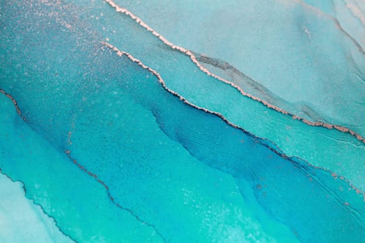 A close-up of abstract art with a blue-green color scheme and gold accents. The colors blend and swirl, creating a dynamic and interesting composition.