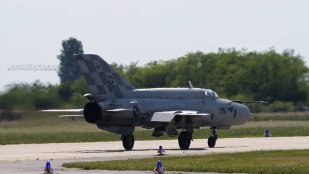 Zagreb Croatia May 11 2024: Soviet-era combat aircraft MiG-21 Fishbed on runway, rear view. Copy Space. Mikoyan Gurevich MiG-21 Fishbed of Croatian Air Force.