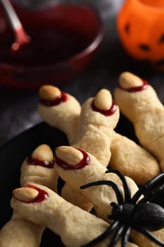 Creepy, scary Witch fingers made from sugar cookies with raspberry jam and almonds on Halloween. Trick-or-treat. Classic Cookie Witch Fingers takes on a healthy, gluten-free, paleo, vegan look.
