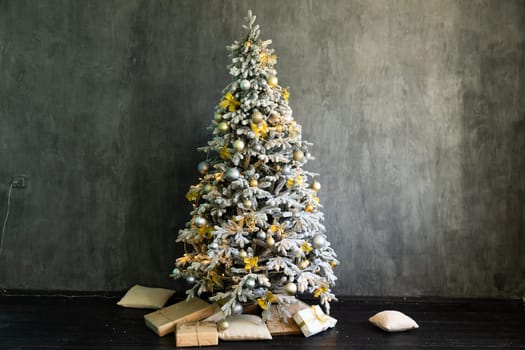 a Christmas tree with gifts and soft pillows in the room for the holiday new year