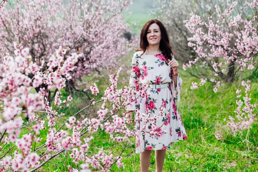 woman's walk in the luminous gardens in a green glade in the fresh air