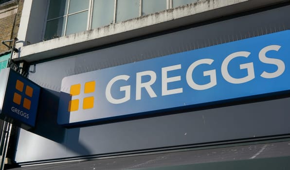 London, United Kingdom - February 03, 2019: Sun shines on Greggs label over their Lewisham shop. They are largest bakery chain in United Kingdom established in 1939