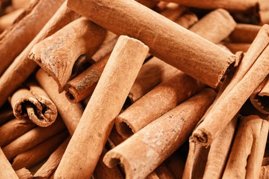 Organic cinnamon stick pile - close up photo.