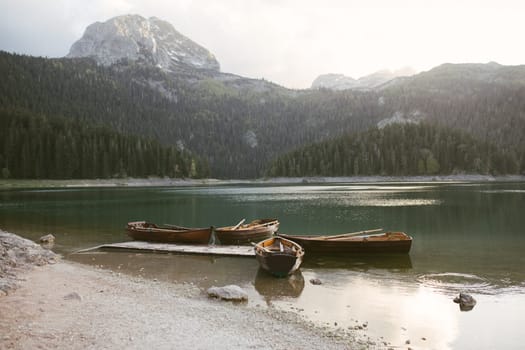 View of the Black Lake or Crno jezero , northern Montenegro. Tourist boats near wooden pier on Black lake in Durmitor national park near Zabljak, Europe. High quality photo