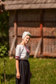 a woman in Ukrainian national costume walks on the lawn