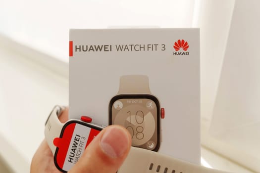 Tyumen, Russia-June 20, 2024: Huawei Watch Fit 3 with a red screen displaying the text AMOLED