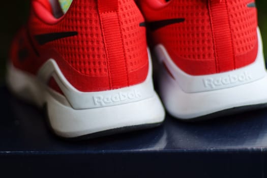 Tyumen, Russia-June 20, 2024: Stylish Red Reebok sneakers for running. Model Nanoflex TR 2.0