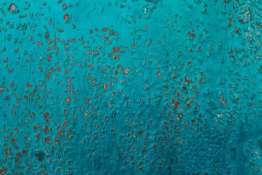 Metal texture covered with old blue paint with scratches and wear