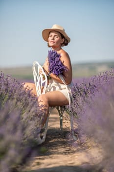 A woman is sitting in a field of lavender flowers and wearing a straw hat. She is smiling and holding a bouquet of flowers. Scene is peaceful and serene, as the woman is surrounded by the beauty of nature.