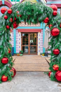 the entrance of the hotel bar restaurant is decorated with Christmas balls. photo