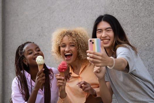 Multiethnic friends with icecream taking a selfie.