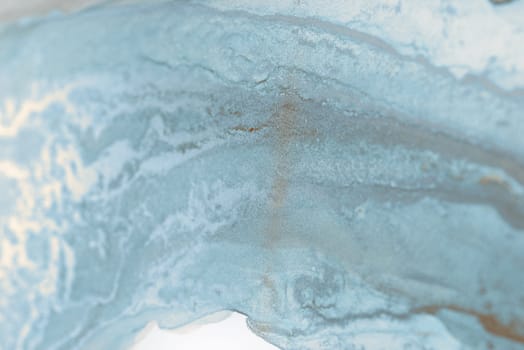 A close-up abstract image showcasing swirling patterns in shades of blue and white. The textures resemble water or ink, creating a dreamy, ethereal effect.