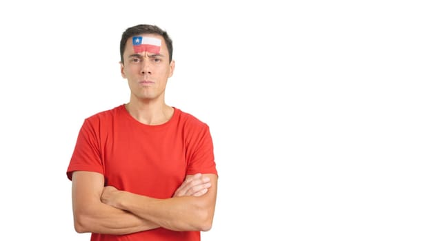 Dignified and serious man with chilean flag painted on face looking the camera with dignity