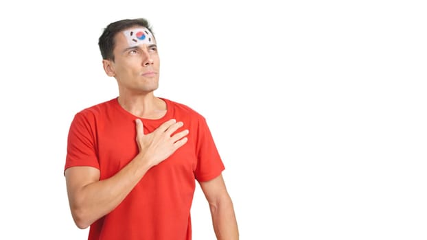 Photo of man listening to the South Korea national anthem with solemnity