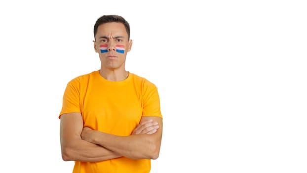 Dignified and serious man with dutch flag painted on face looking the camera with dignity