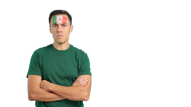 Dignified and serious man with mexican flag painted on face looking the camera with dignity
