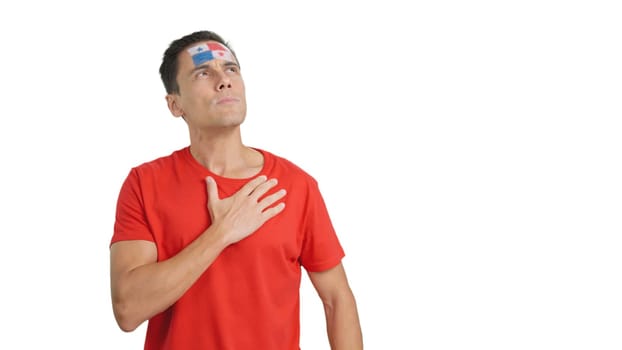 Photo of man listening to the Panama national anthem with solemnity