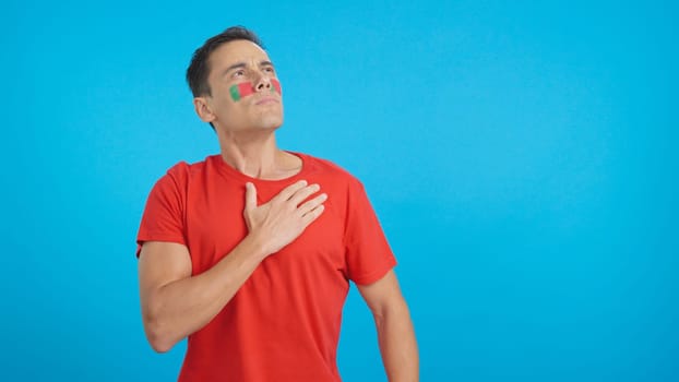 Man listening to the Portugal national anthem with solemnity
