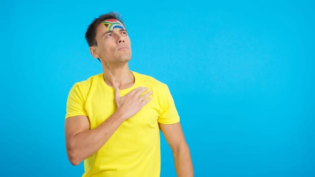 Photo of Man listening to the South Africa national anthem with solemnity