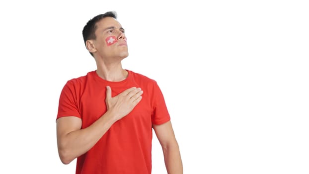 Photo of Man listening to the Switzerland national anthem with solemnity