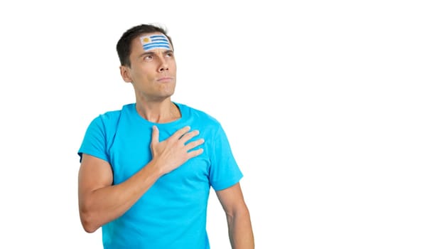 Photo of Man listening to the Uruguay national anthem with solemnity