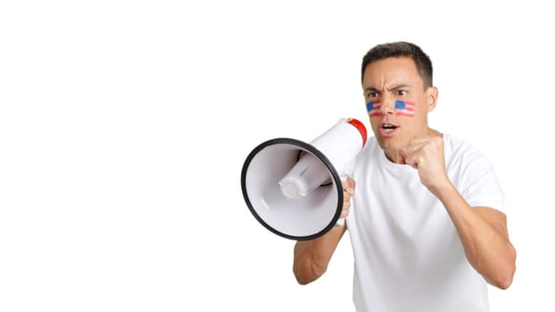 Man with a USA flag painted on his face rallying the crowds using a megaphone