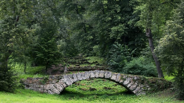 Stone bridge in a suburban historical park.