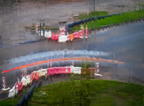 Shot of the light trails from the cars on the road, made trough window during the rain