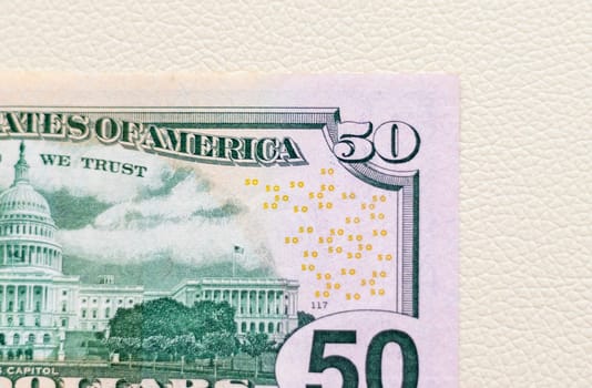 Close up shot of the US dollars note bill on the white leather background