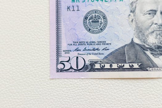 Close up shot of the US dollars note bill on the white leather background