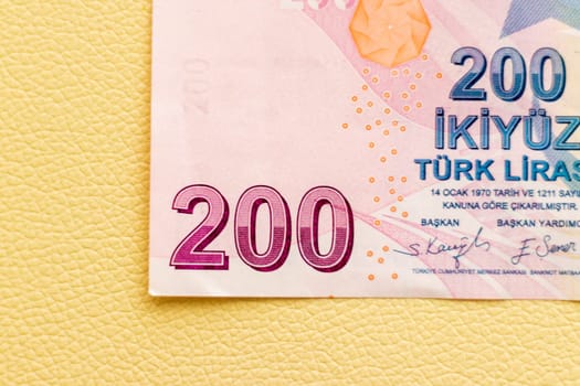 Close up shot of the Turkish lira note bill on the white leather background.
