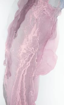 A close-up image of abstract pink and gray ink swirls on a white background. The ink creates a beautiful, flowing pattern.