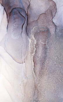 A close-up image of abstract ink art, showcasing swirling patterns in shades of silver and gray, resembling flowing water or clouds.