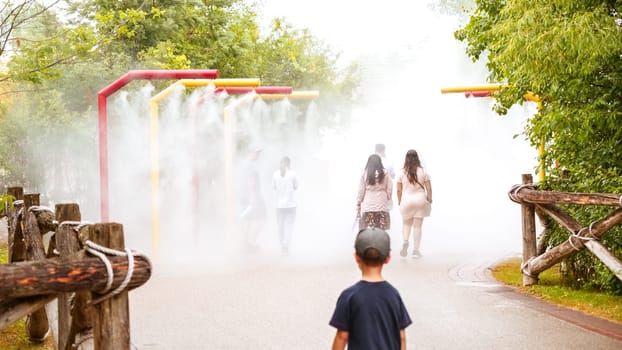 Family Fun In The Cooling Water Mist On A Hot Summer Day At The Amusement Park Toronto ON Canada - 22.12.22.