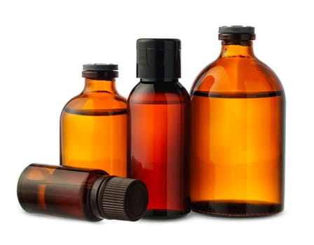 A group of amber glass bottles of essential oils and a cream jar are arranged on a white background.