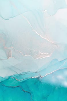 A close-up image of teal and white ink swirling together, creating a beautiful abstract pattern.