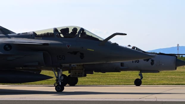 Zagreb Croatia May 11 2024: Modern Fighter Jet Parked Close to a Vintage Soviet Era Combat Aircraft. Dassault Rafale and Mikoyan-Gurevich MiG-21 Fishbed of Croatian Air Force. Copy Space